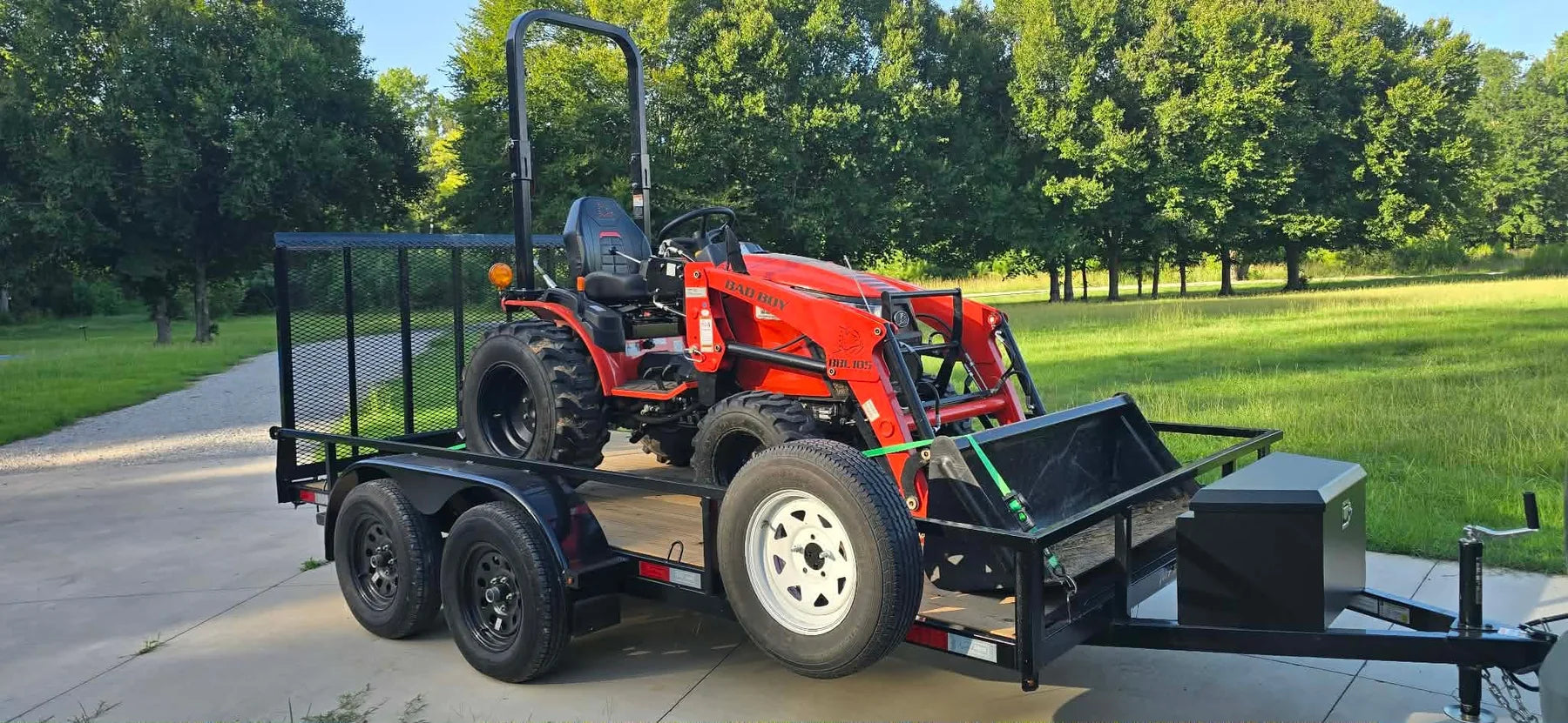 Compact tractor loaded on utility trailer
